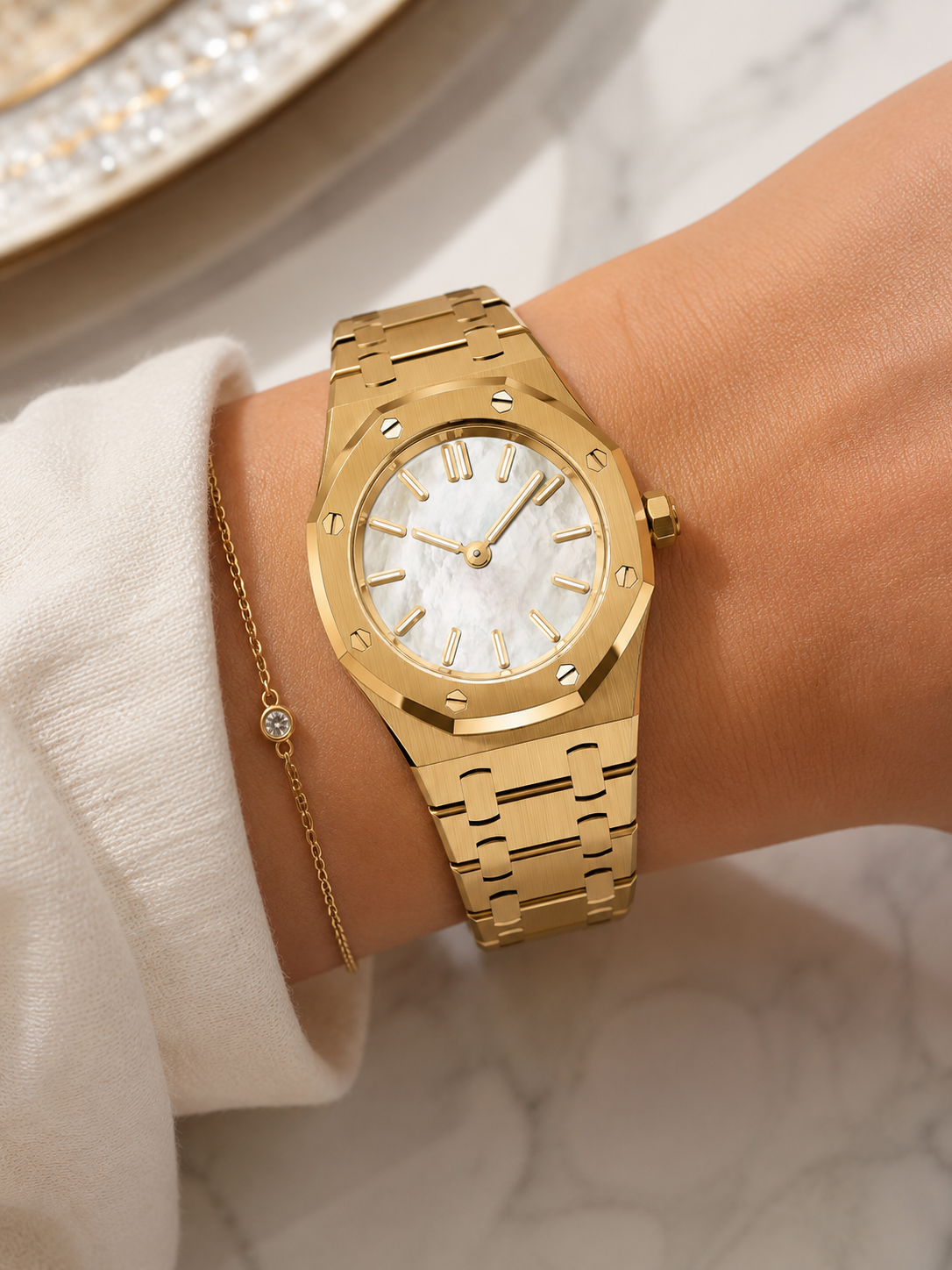 The Aurelia — yellow gold watch with mother-of-pearl dial on a woman's wrist