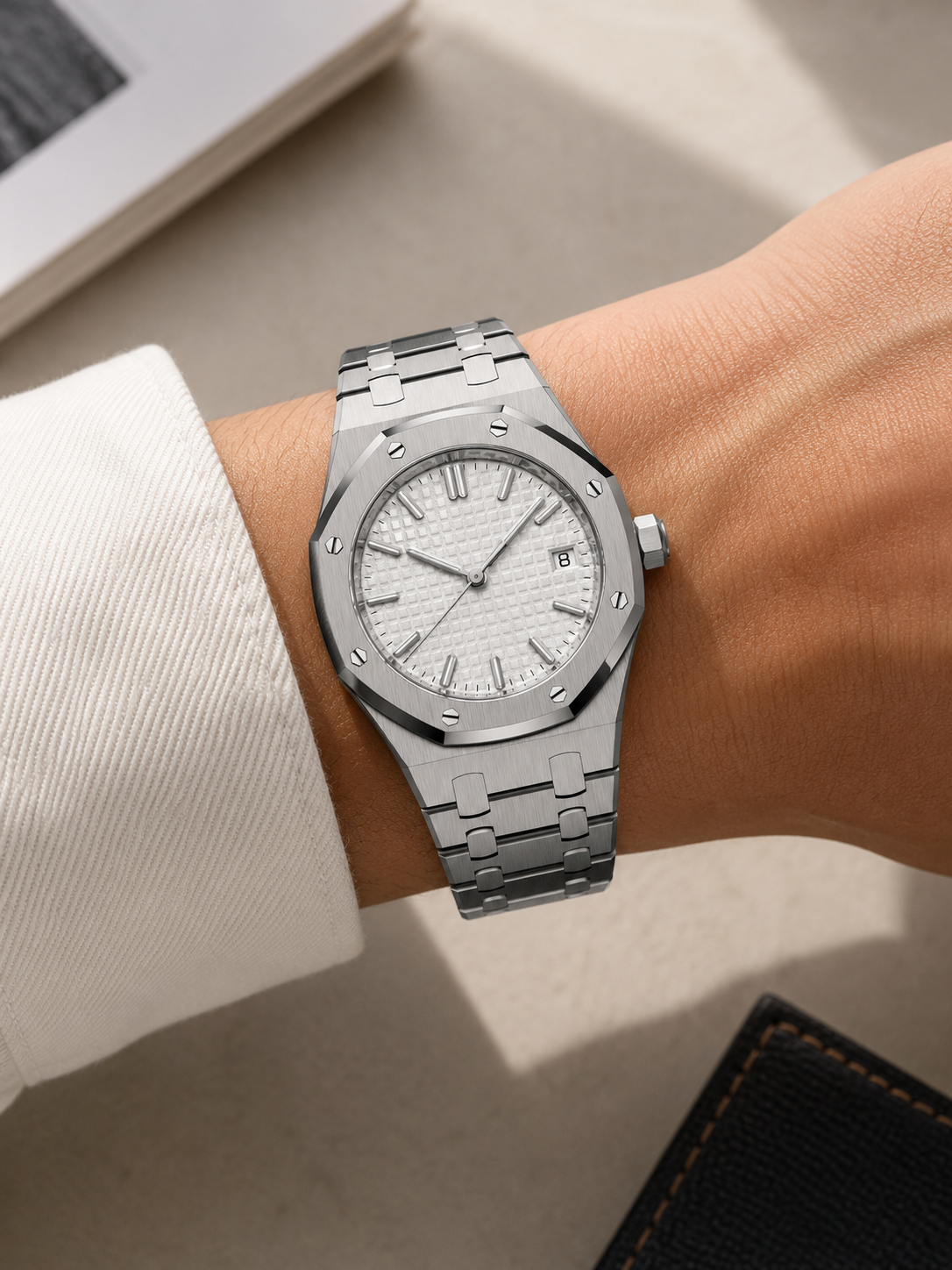 The Lumen — steel watch with white tapisserie dial on a woman's wrist